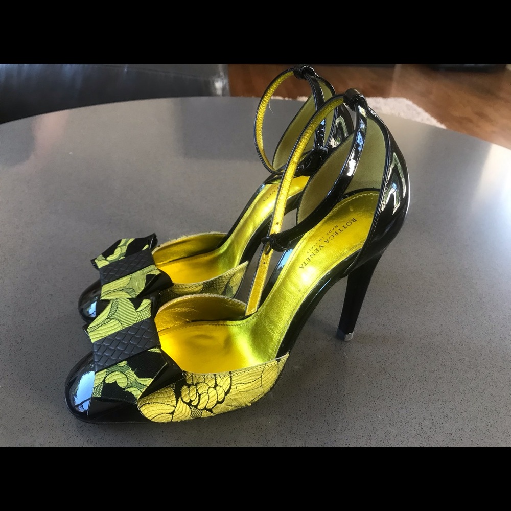 Bottega Veneta gold and black ankle strap heels.